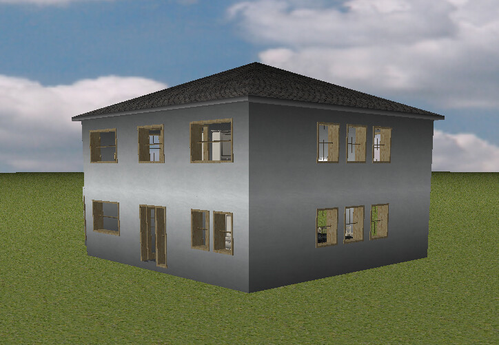 Two-story gray house with many windows standing on green lawn, clear sky with clouds.