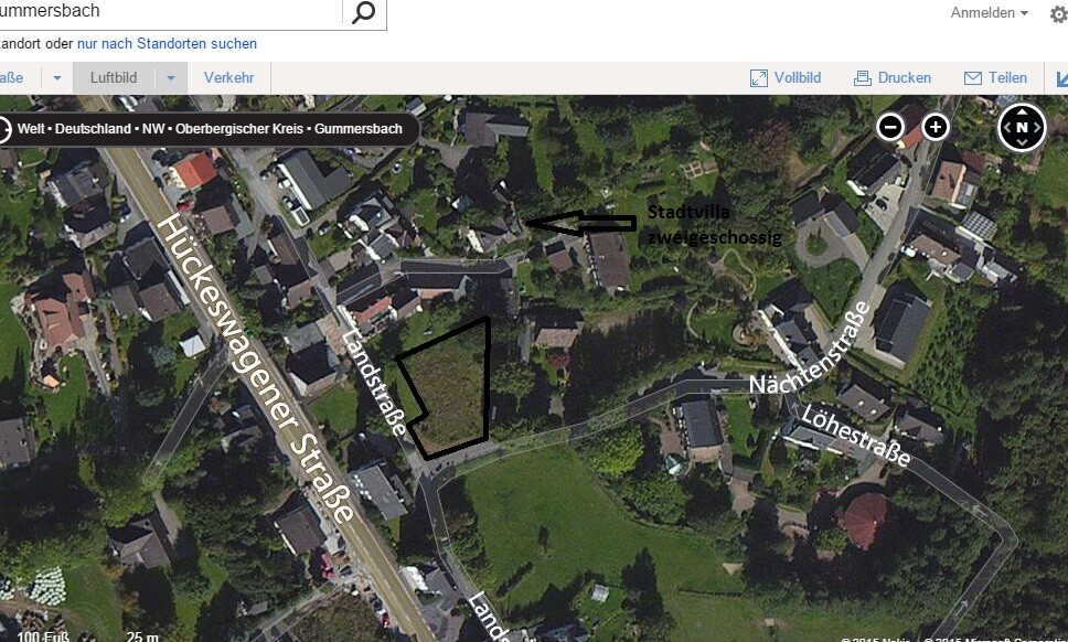 Satellite image of a residential area with marked building plot and surrounding streets.