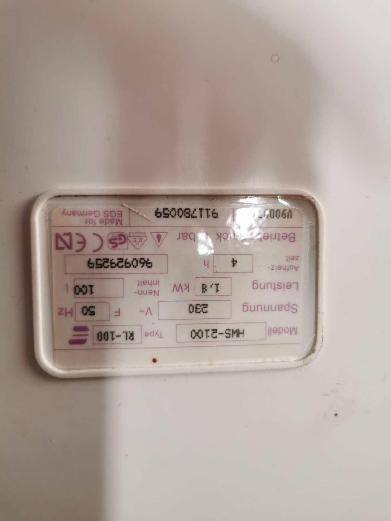 Weißes Gehäuse mit pinkem Typenschild, enthält technische Daten und Symbole.