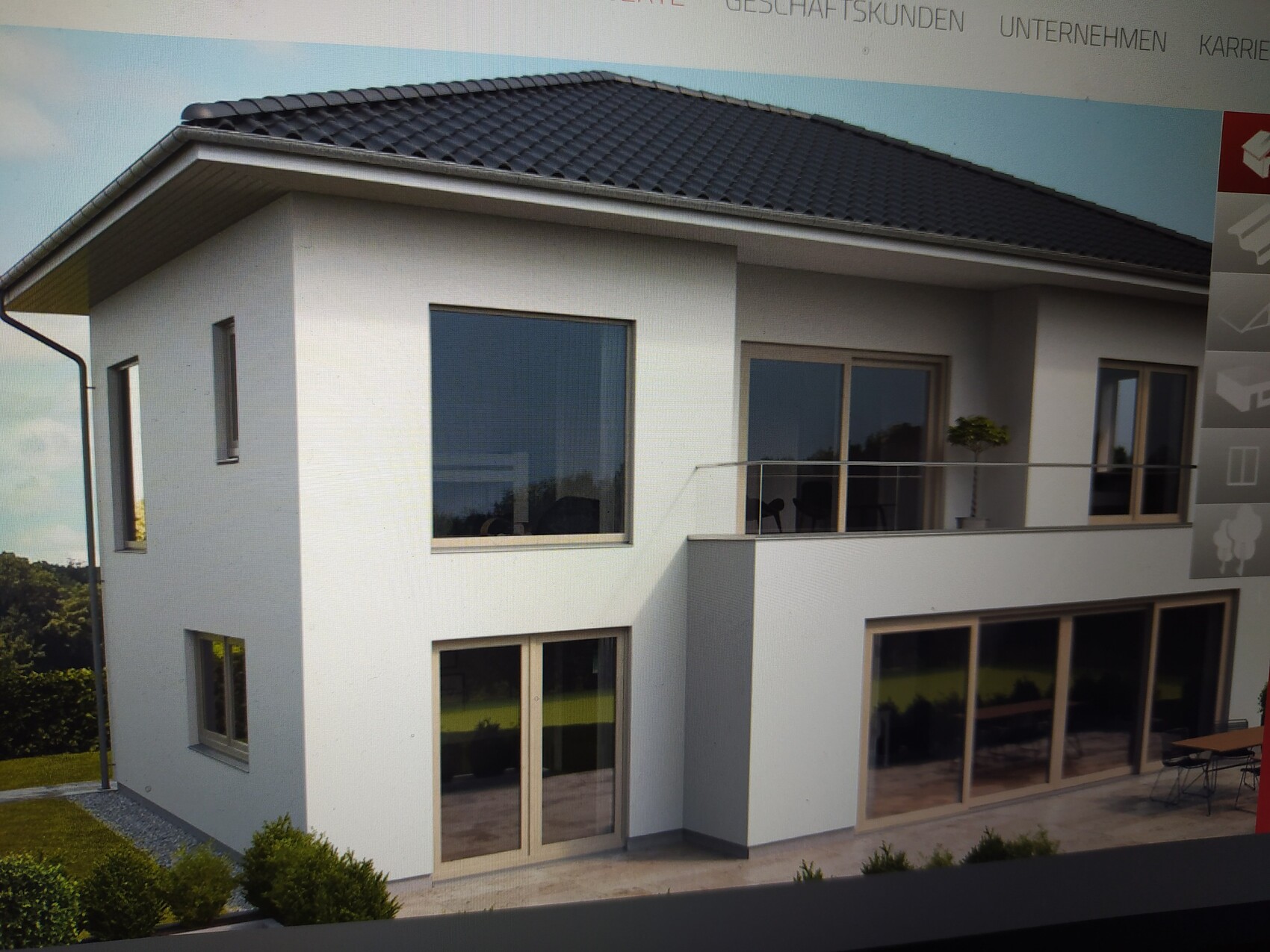 Modern two-story white house with large glass fronts, balcony and terrace.