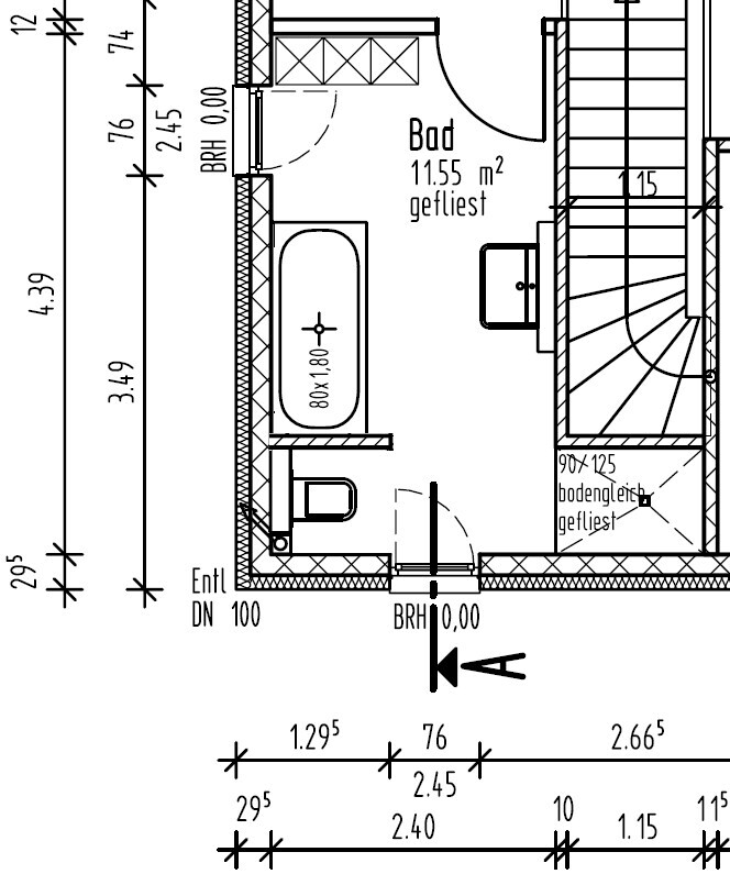 Floor plan of a bathroom with bathtub, toilet, and staircase in a house.