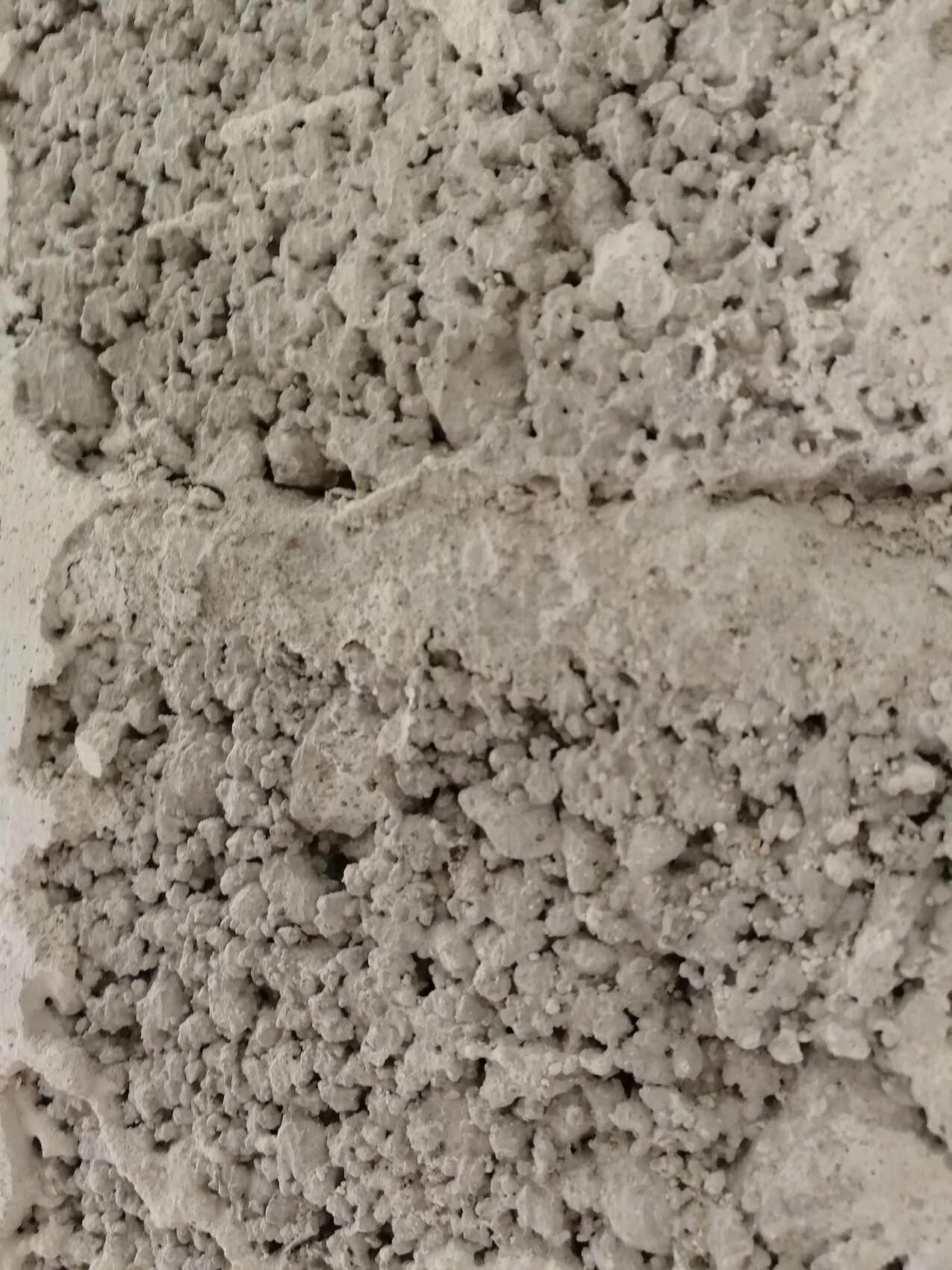 Gray, coarse concrete or cement powder with small clumps.