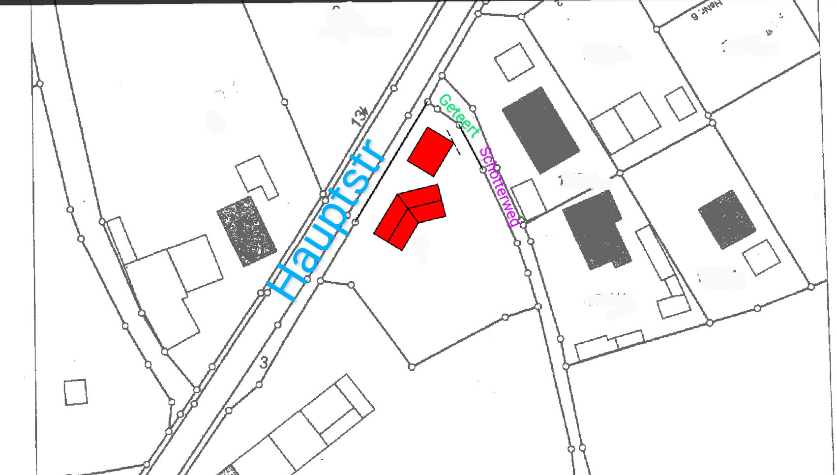 Site plan: diagonal main road, two red buildings in the center, surrounding plots