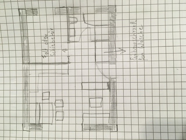 Hand-drawn floor plan of an apartment on graph paper: rooms, doors, furniture (tables/chairs).