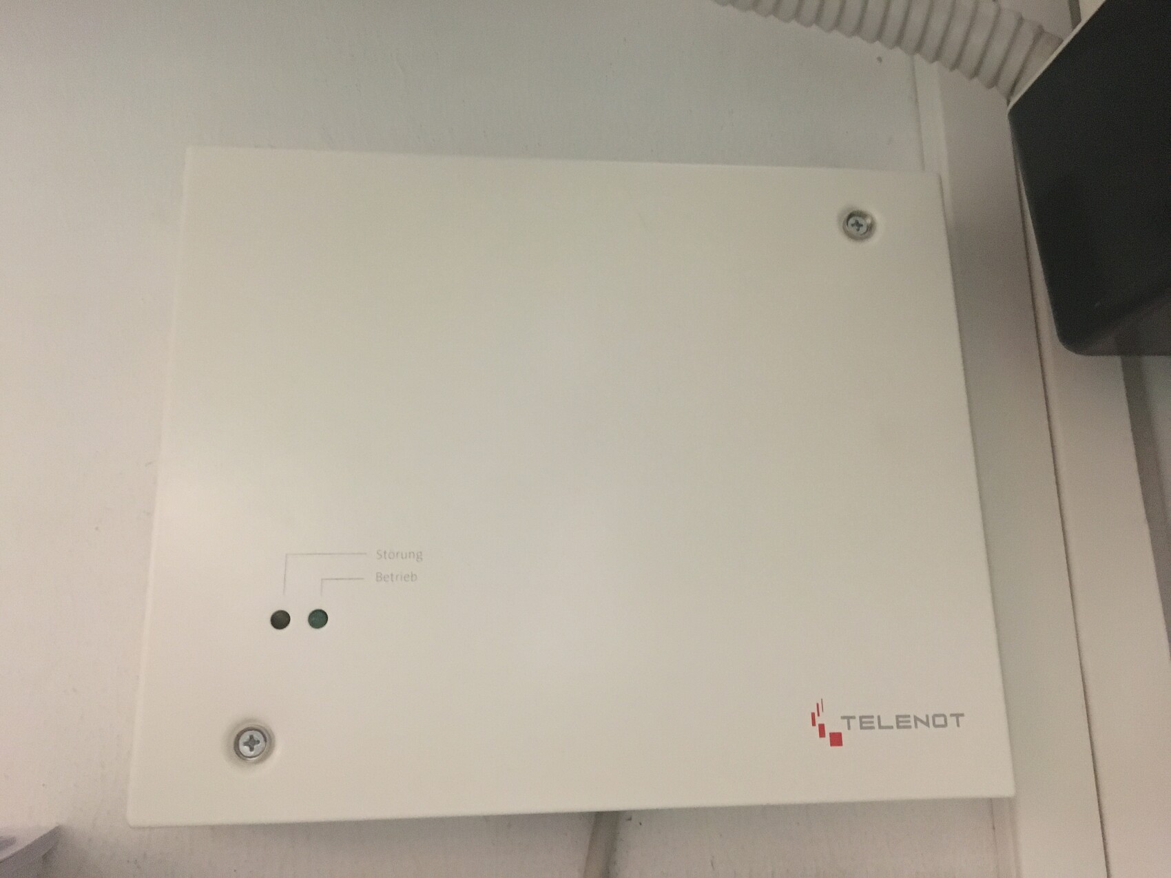 White metal box with two LEDs (fault and operation) and TELENOT logo.