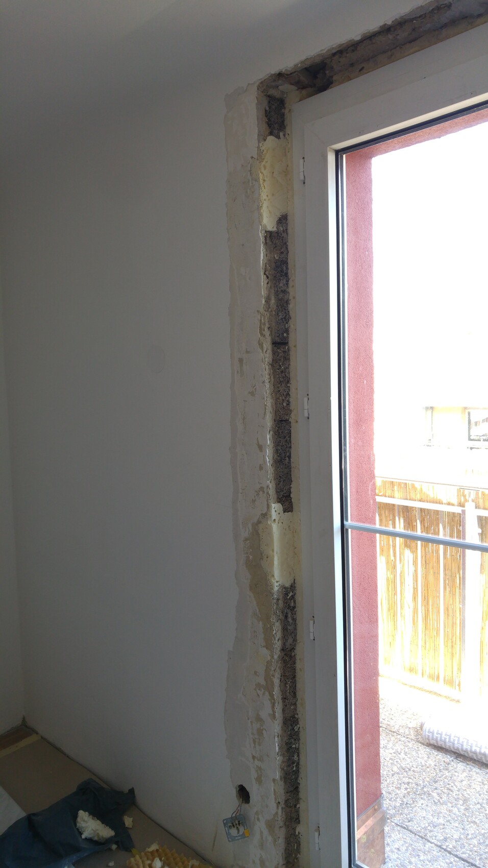Interior renovation work with exposed wall and window frame