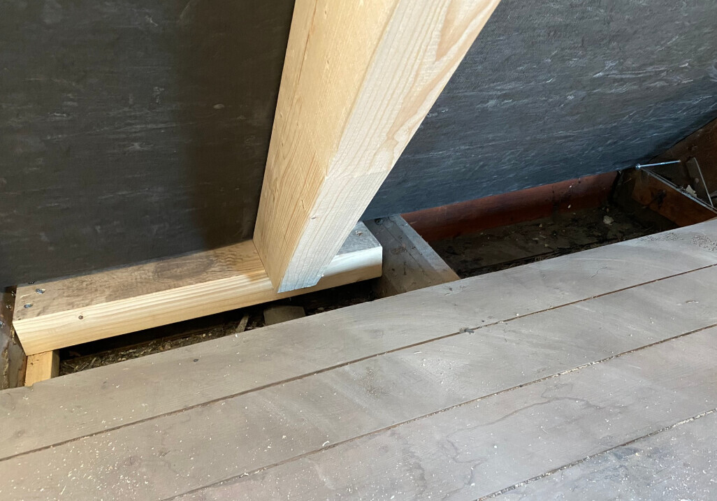 Unprocessed wooden structure with floor joists and floorboards in shell construction