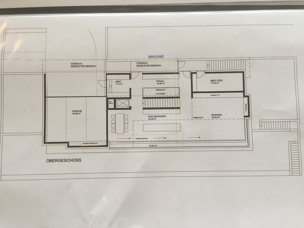 Floor plan upper floor with garage, kitchen/dining, living, storage rooms, stairs