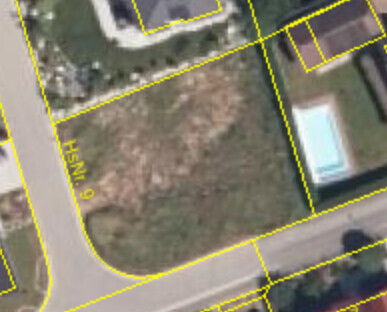 Aerial view of a plot with yellow parcel outlines along a street.