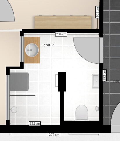 Floor plan of a small bathroom with washbasin, toilet and door