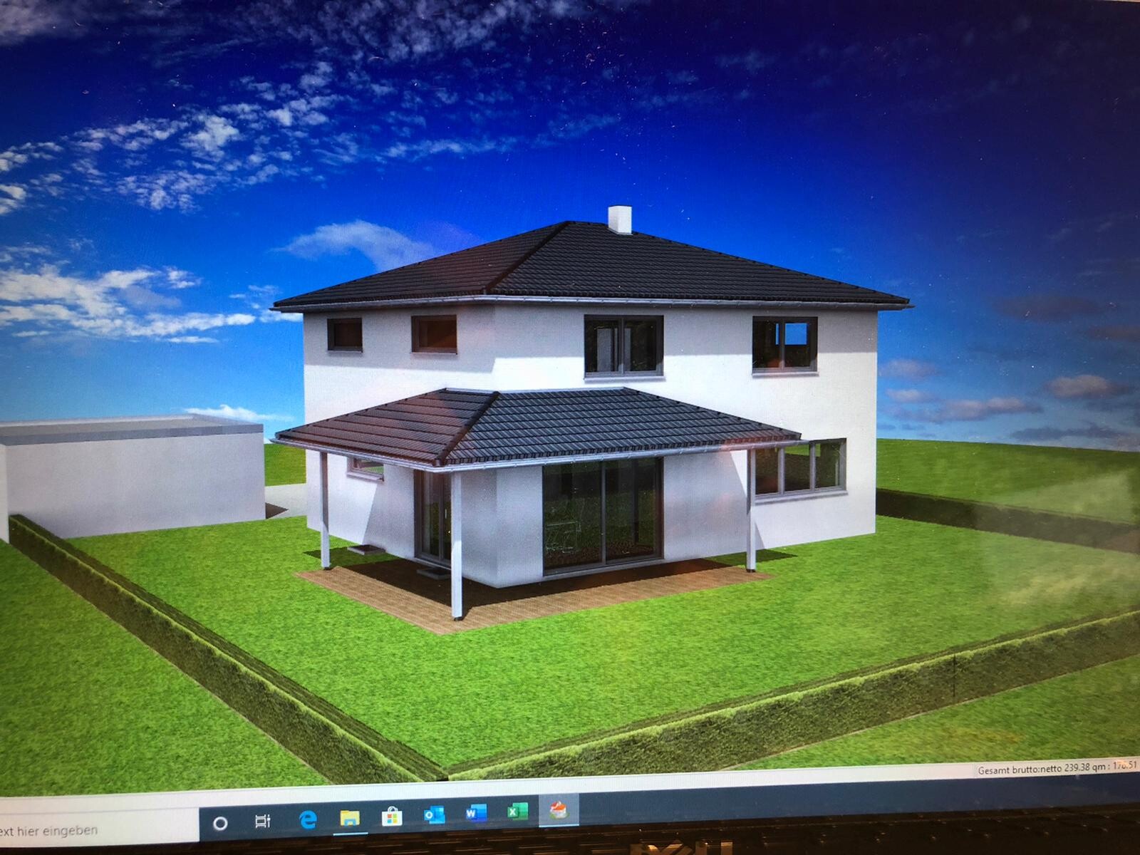 Two-story white house with dark roof, glazed veranda and green garden, blue sky.