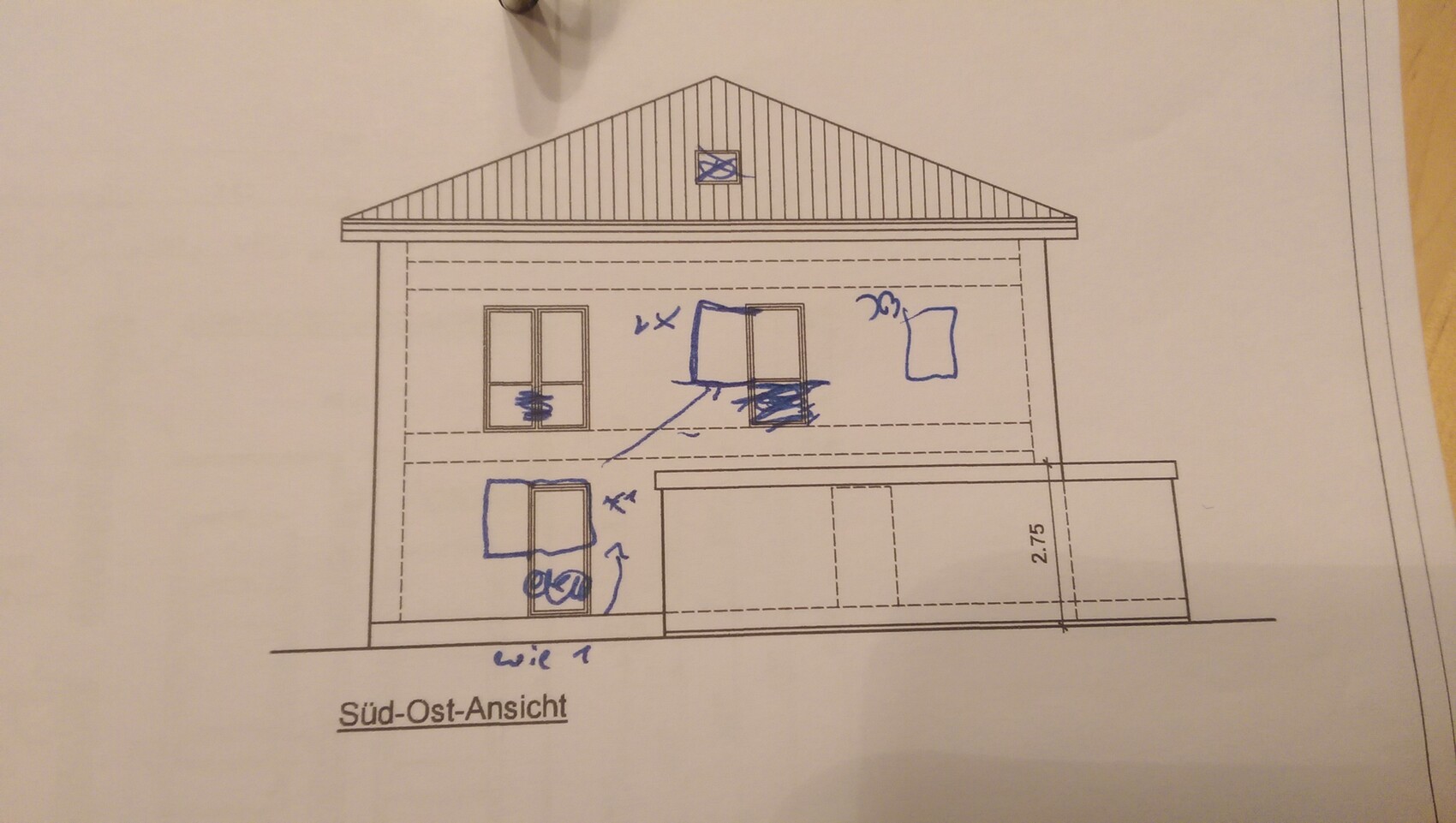 Southeast view of a two-story house with a pitched roof and garage extension on the right side.