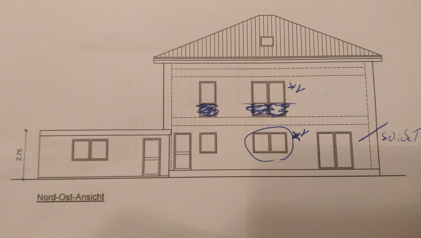 Northeast view of a house with an extension on the left, several windows, blue markings.