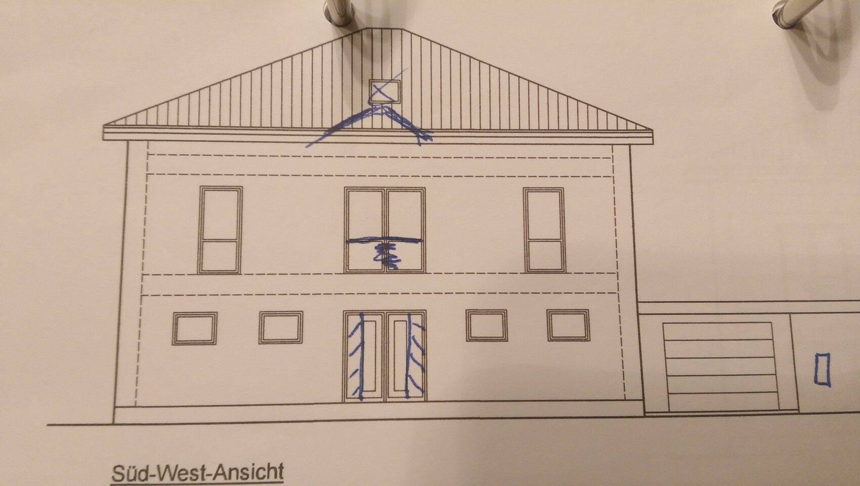 Southwest view of a two-story house with windows and garage on the right.