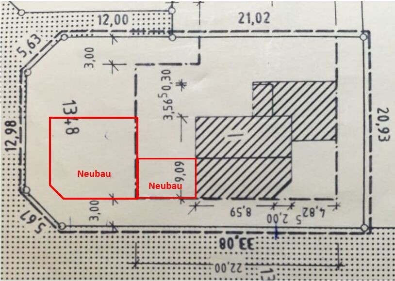 Site plan of a building plot with two new buildings marked in red, left larger, right smaller.