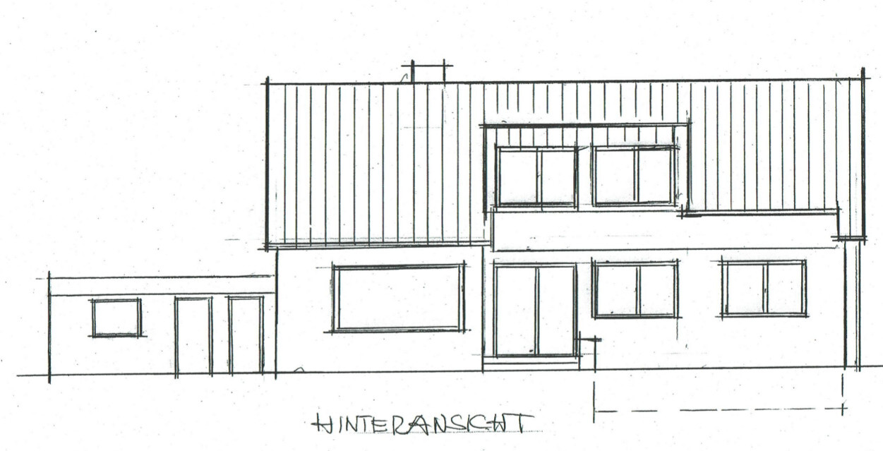 Rear view of a two-story house with entrance stairs and large windows.