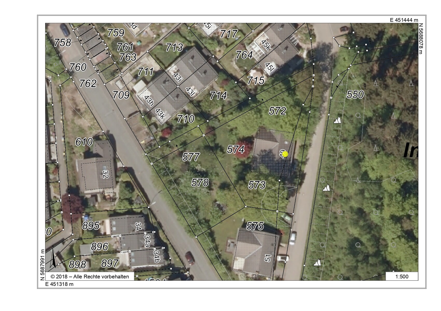 Aerial view of a residential area with parcel boundaries, numbers, and surveying lines.