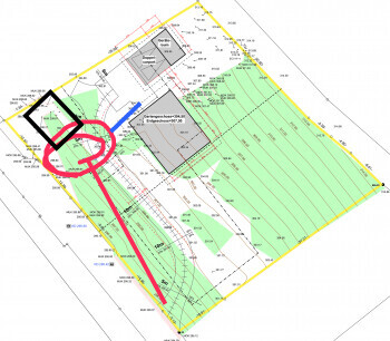 Site plan of the building plot with building areas, driveway, and green spaces