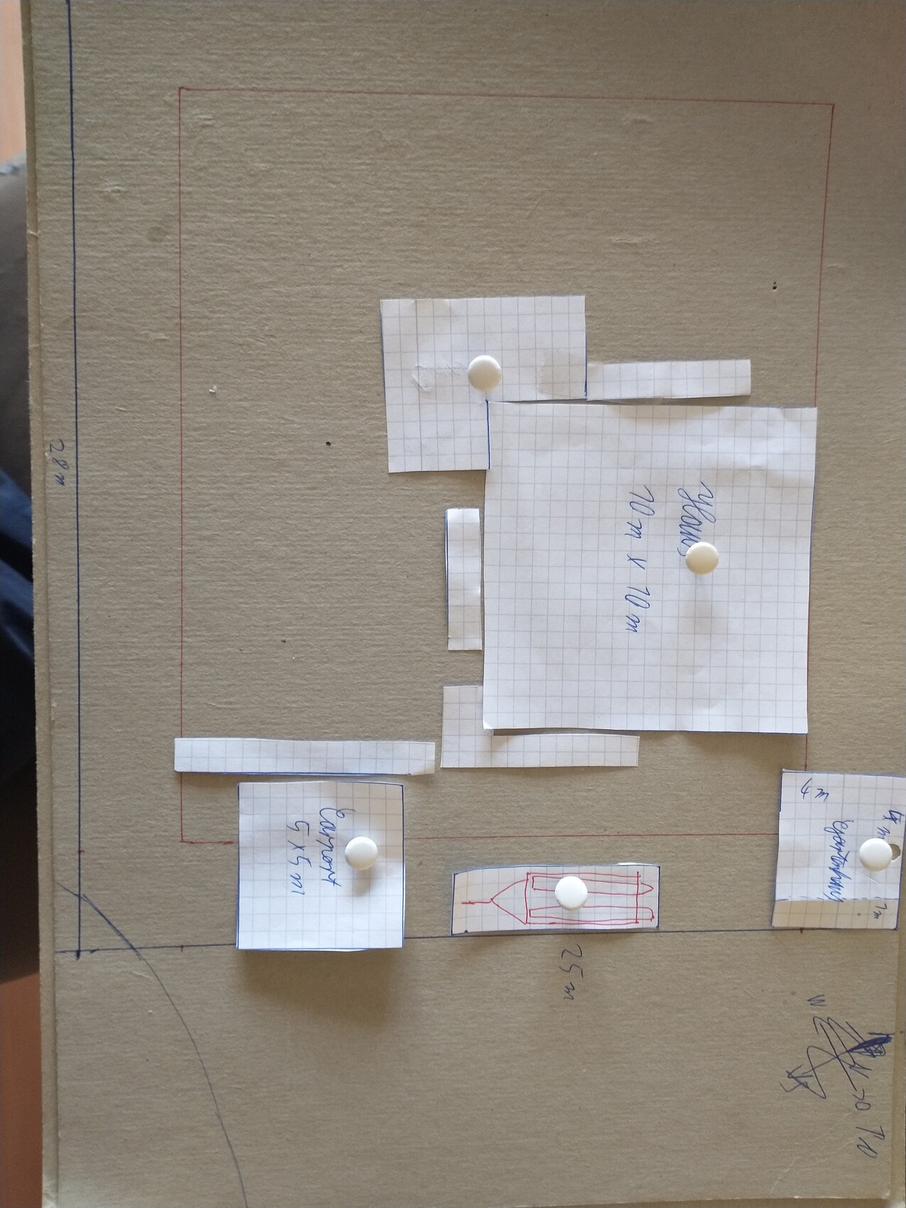 Cardboard base with cut paper squares for house floor plan planning