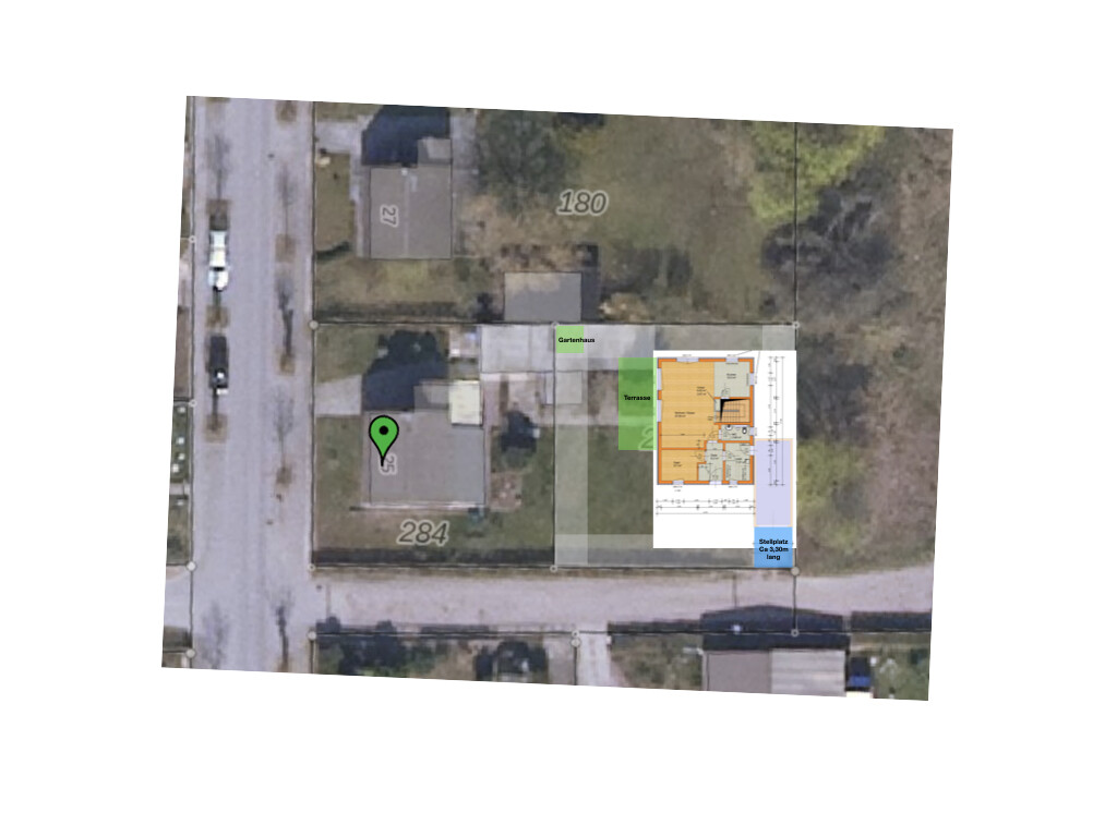 Aerial view of a residential area with a green pin on a plot and overlaid floor plan.