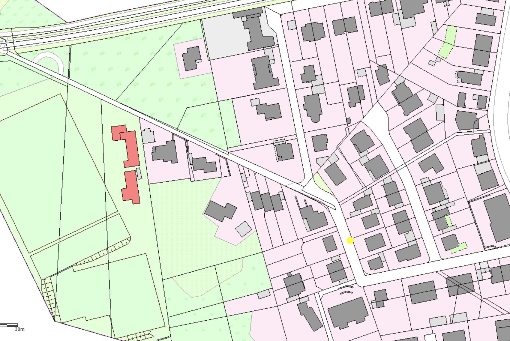 City map: street network and plots in pink, green areas, red buildings on the left, yellow dot.