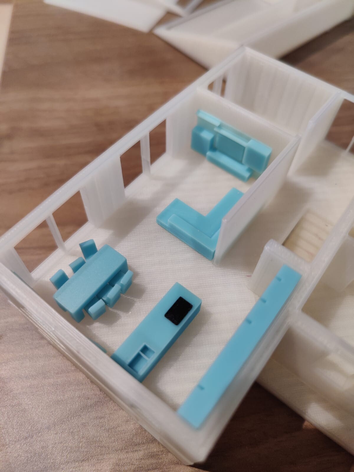 Small interior design: white walls, light blue furniture (sofa, chairs) made of plastic.