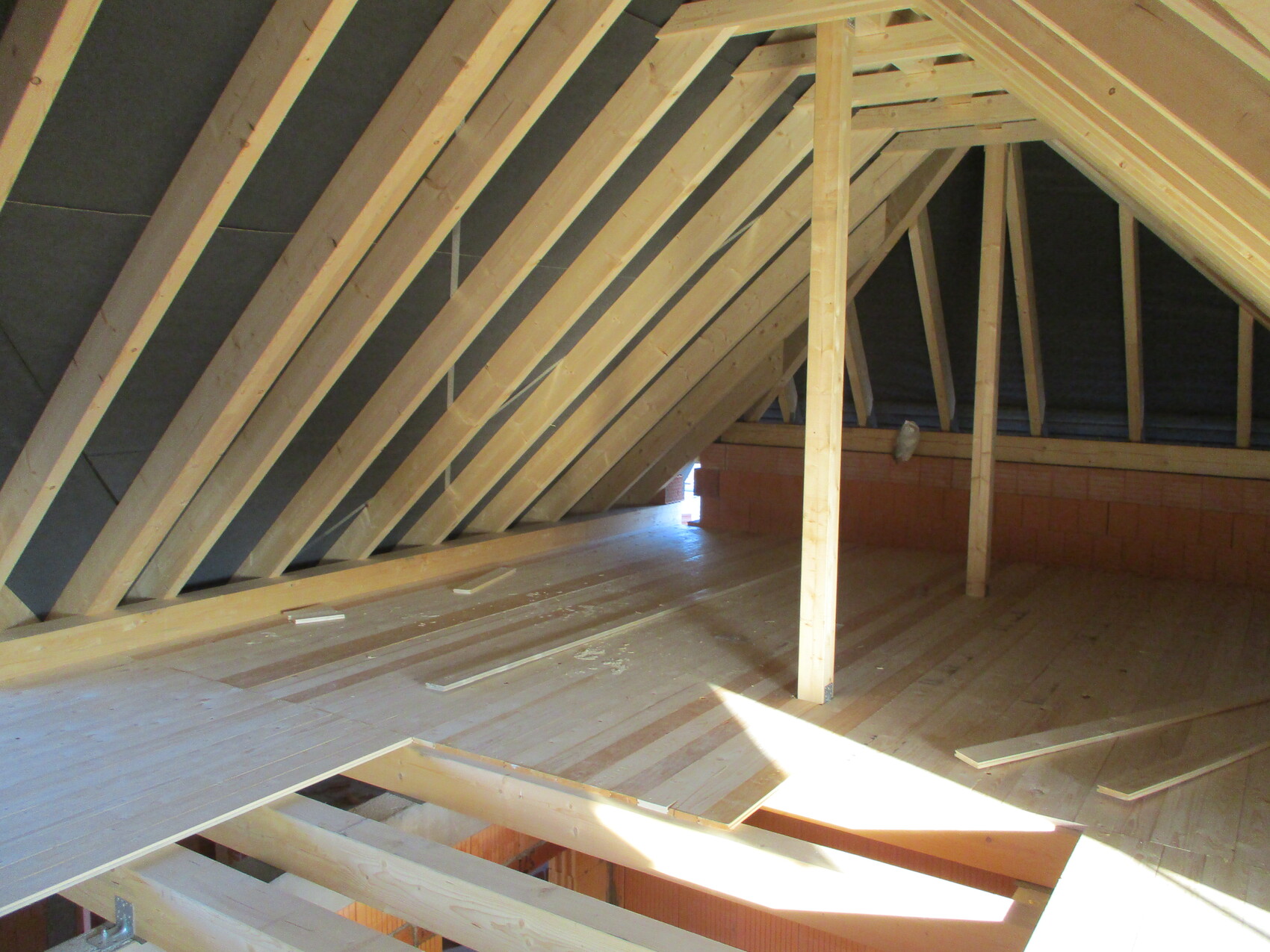 Attic with visible wooden rafters and shell construction in the attic.
