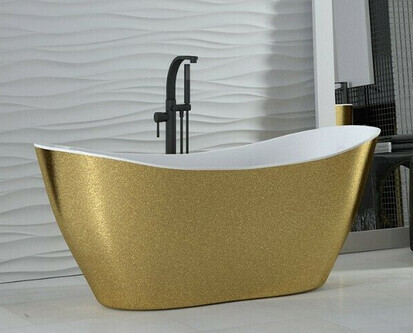 Modern golden freestanding bathtub with black fittings in a bright bathroom.