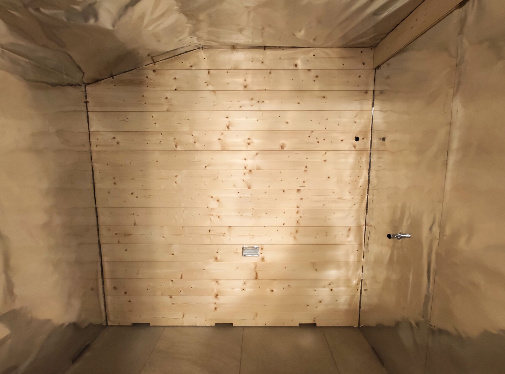 Light wooden panel wall made of horizontal planks in an insulated interior.