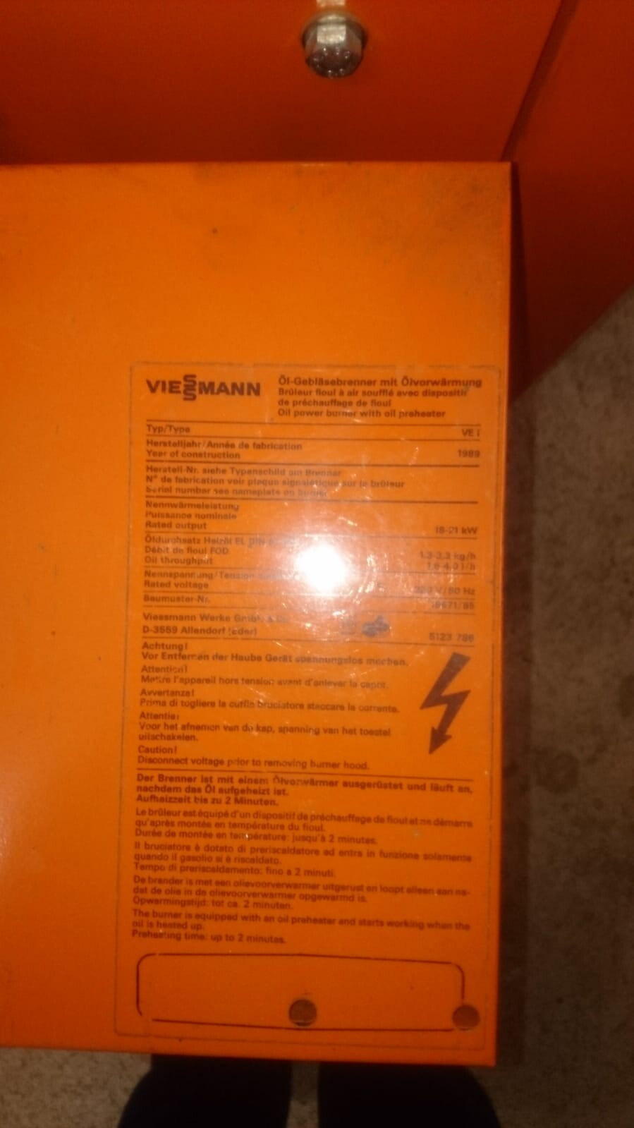 Orange Viessmann oil burner with sticker and warning notice
