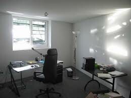 Bright home office with desk, chair and window in a bright room