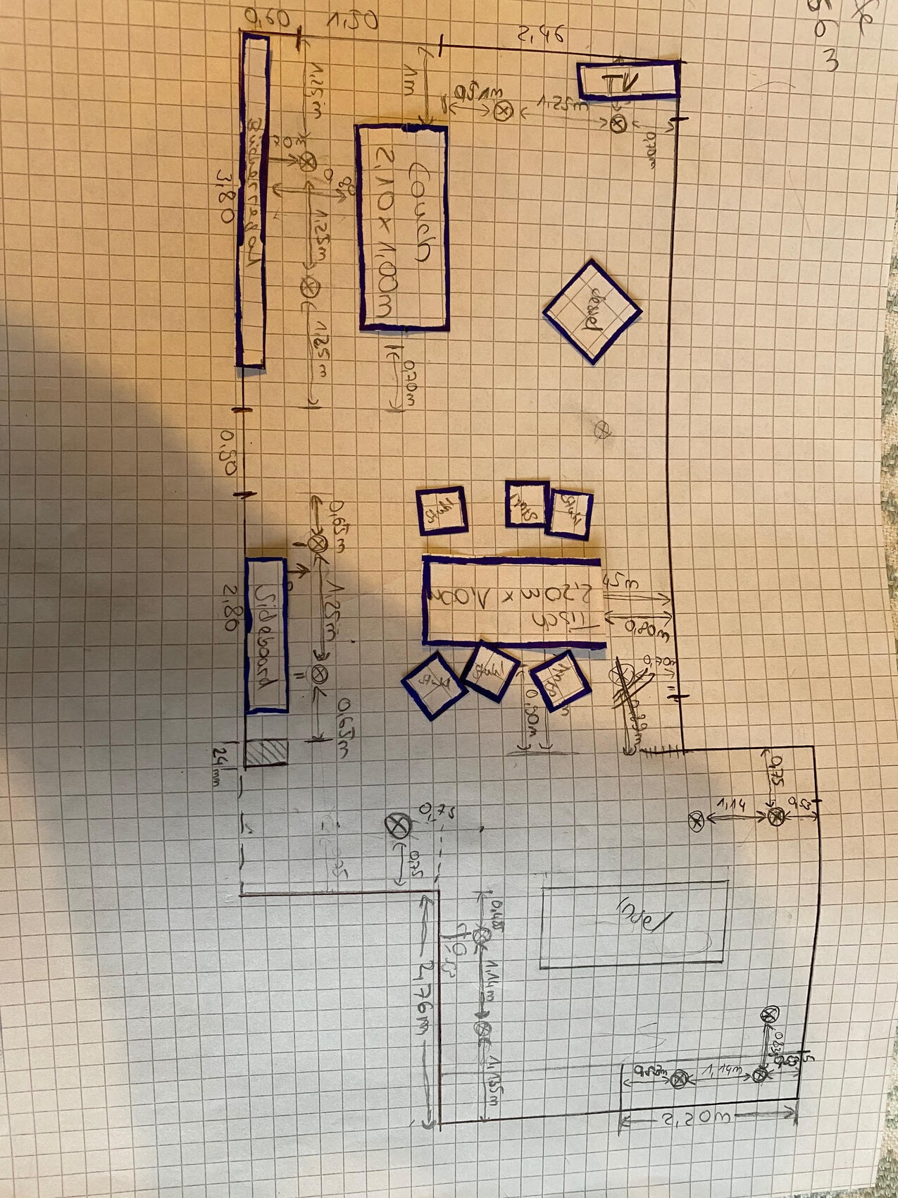 Hand-drawn floor plan of a living and dining area with dining table, chairs, and kitchen island.