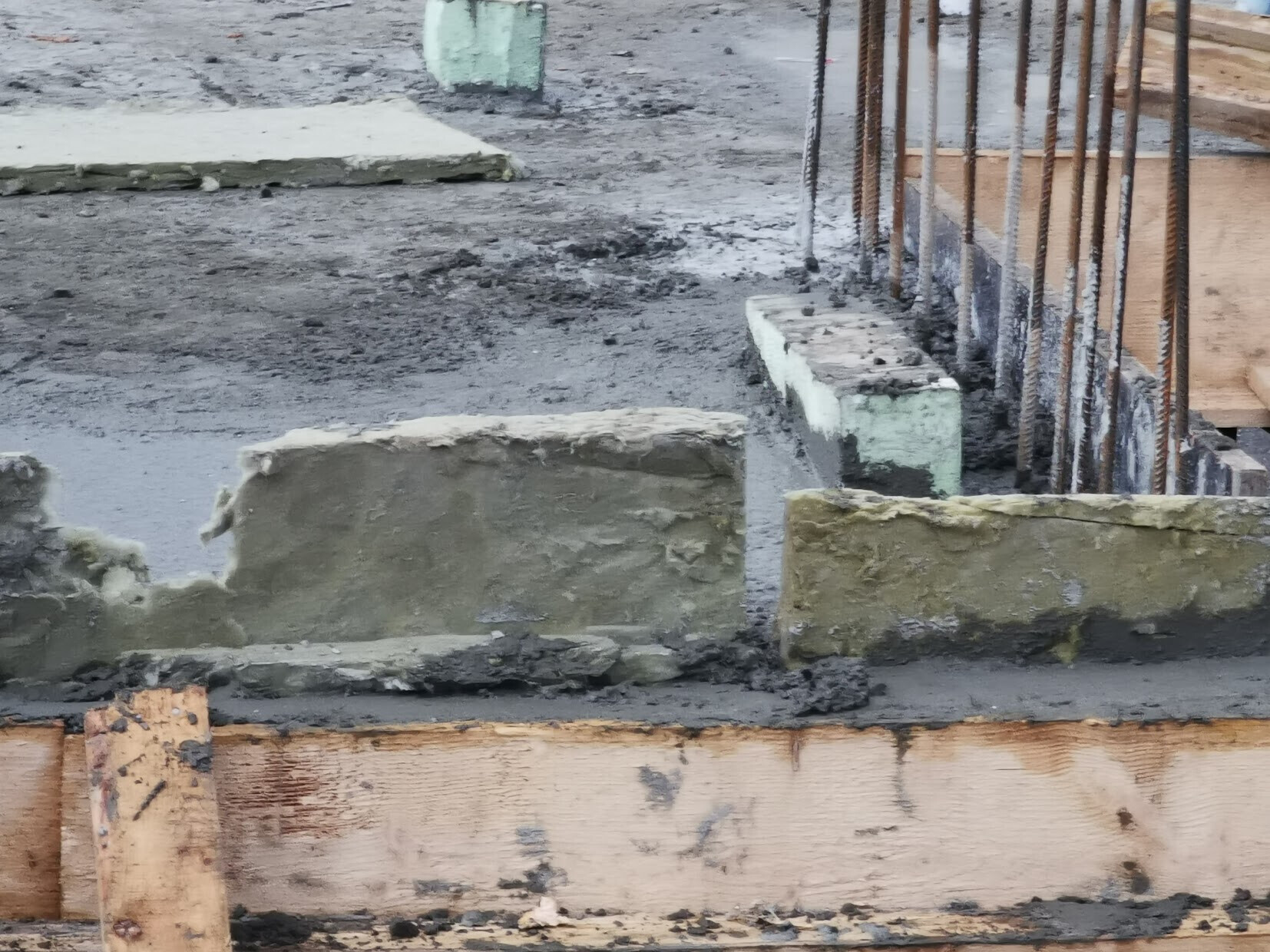 Construction site foundation: concrete block, reinforcement, and wooden forms