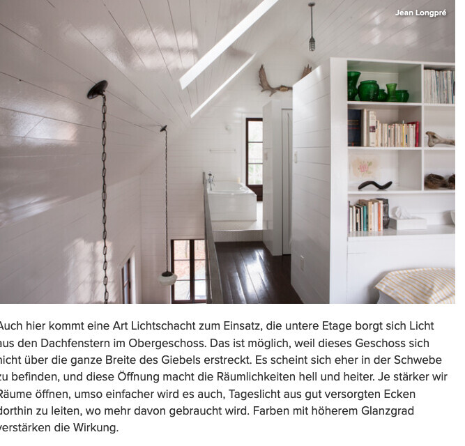 Bright attic with shelving unit on the right, books, green vases, dark wooden floor.