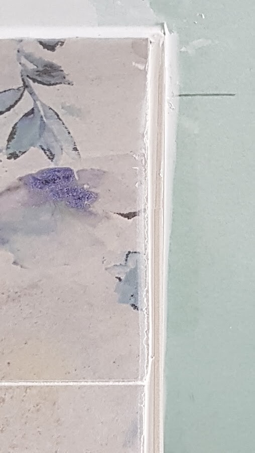 Small framed watercolor: violet flower on light background.