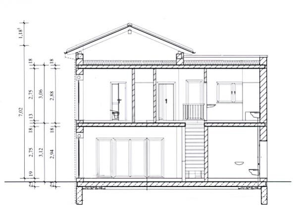 Cross-section through a two-story house with foundation, staircase, and interior layout