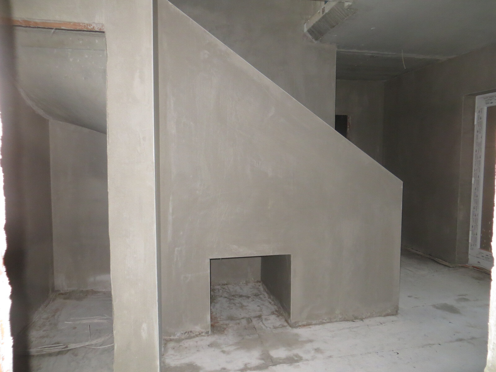 Interior construction site: untreated concrete walls and partition wall inside