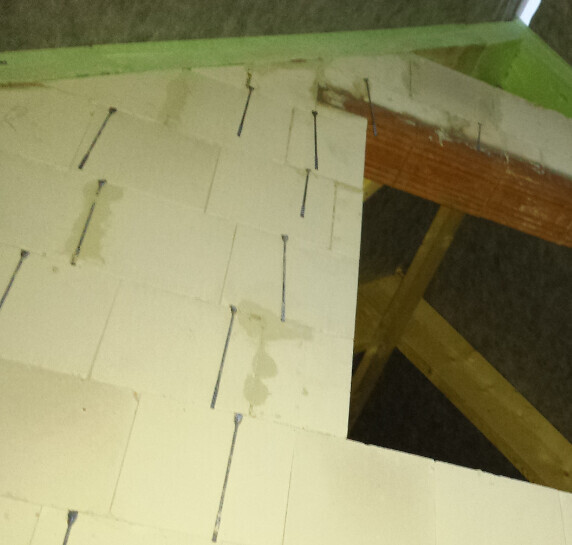 White polystyrene insulation panels nailed to a wooden frame (roof structure).