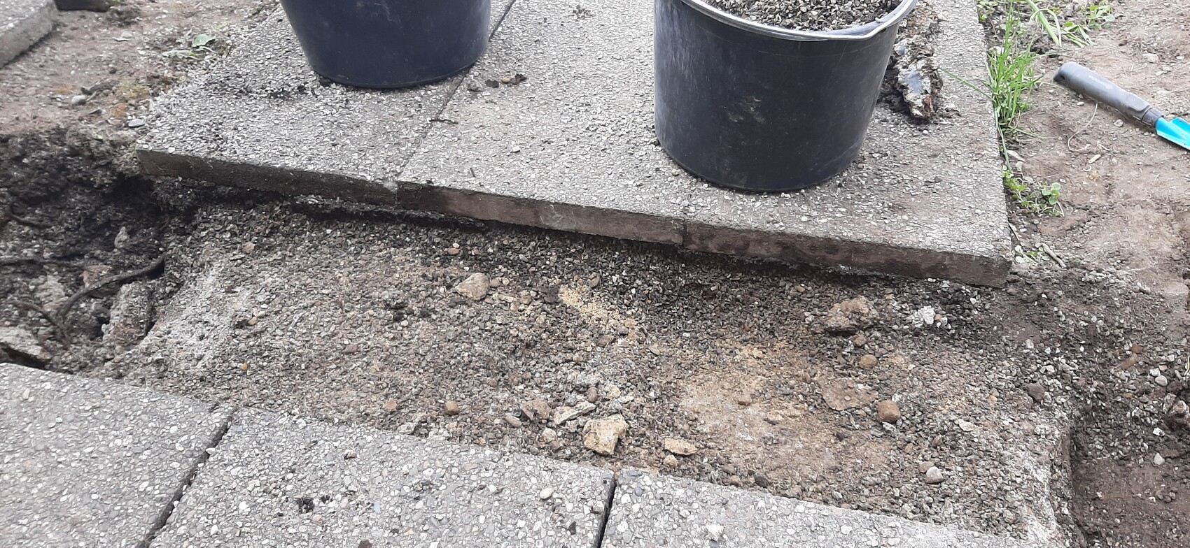 Construction site with concrete slab and soil, foundation preparation