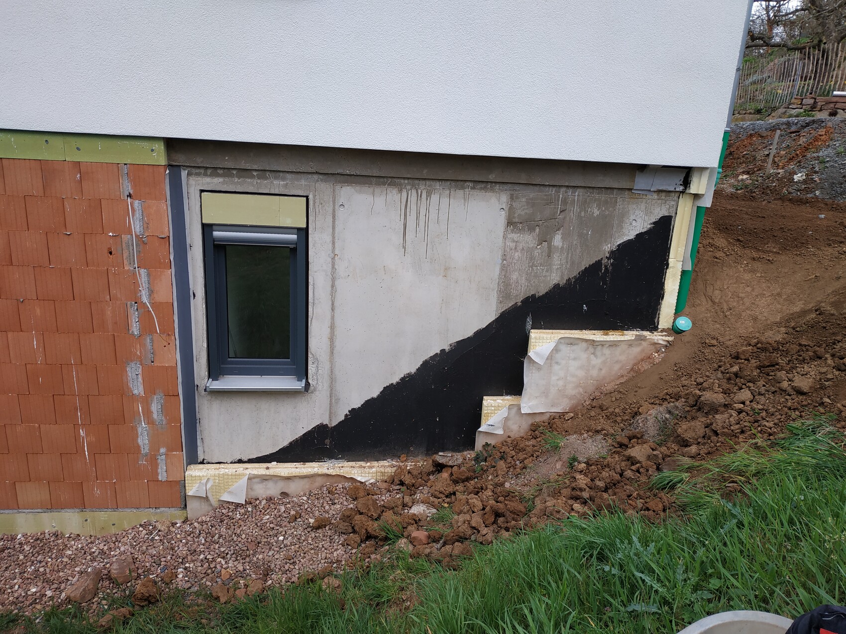 Basement foundation with waterproofing, window and excavation at new build