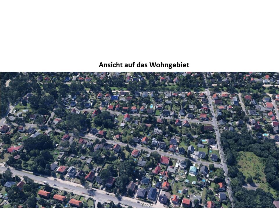 Aerial view of a residential area with many houses, streets, and trees.