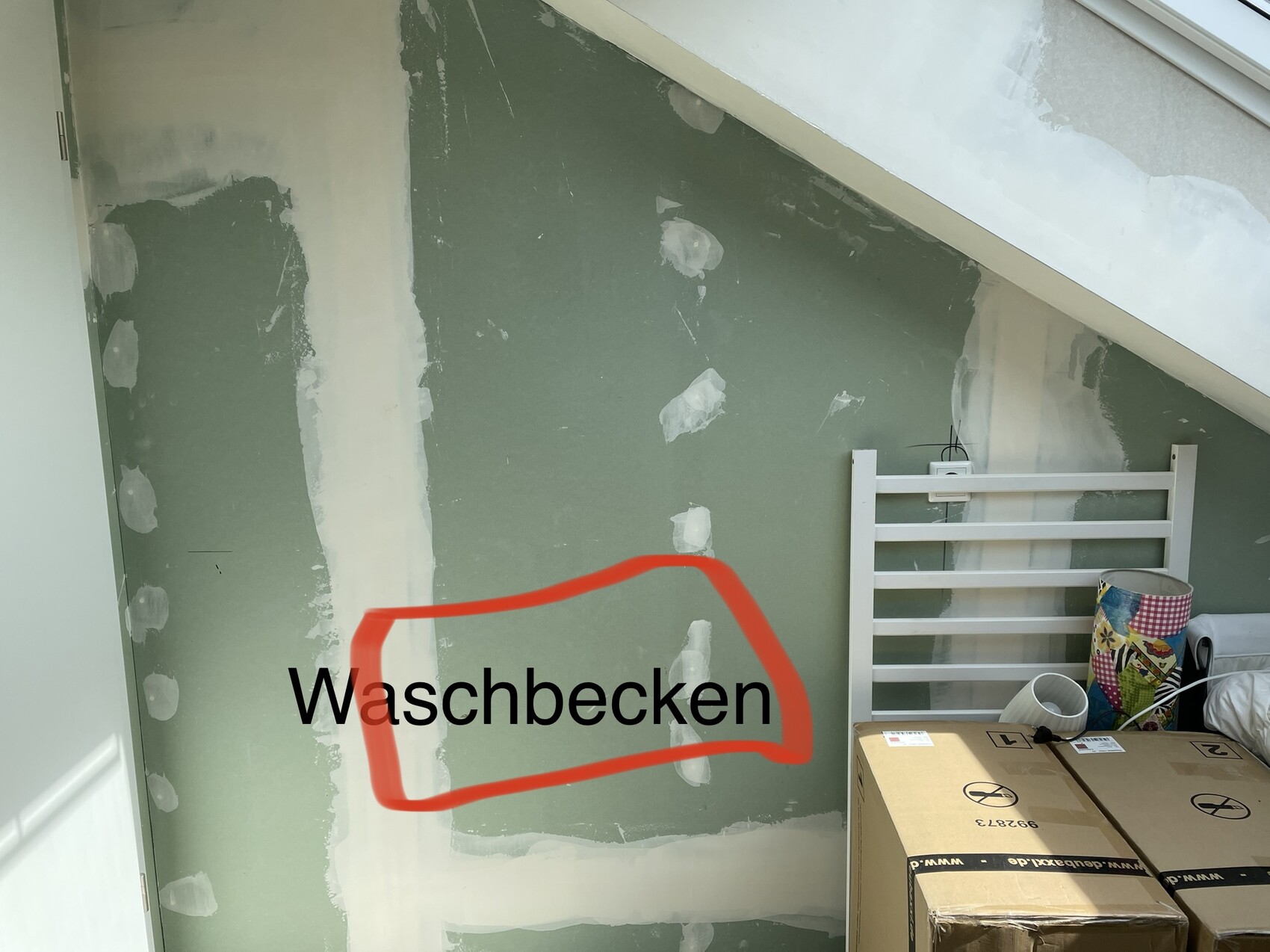Renovation room with green drywall partition; red outline marking 'sink' area