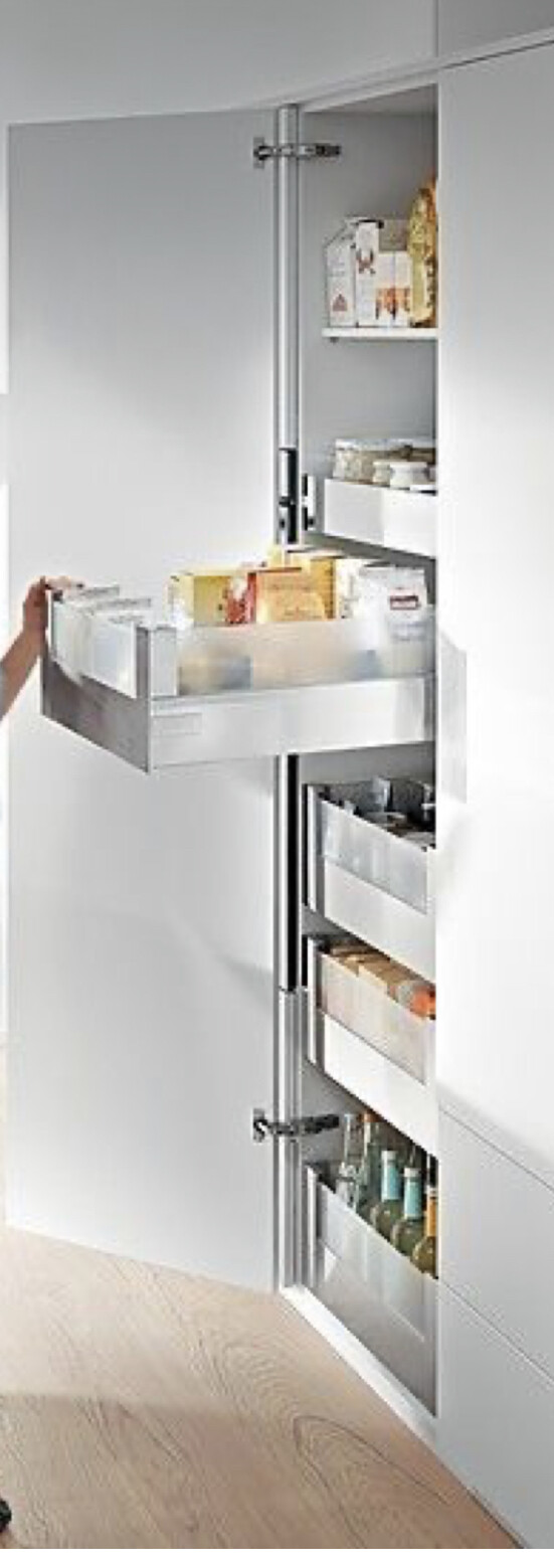 Tall cabinet with pull-out drawers; visible supplies, packages, and bottles.