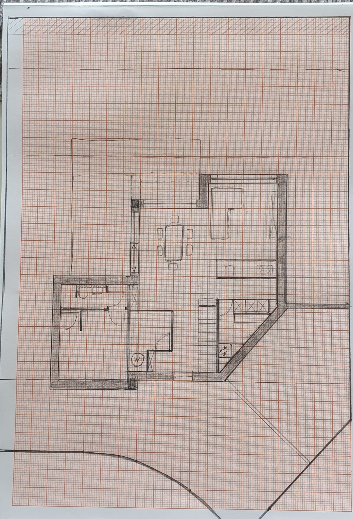 Rough house floor plan on graph paper showing dining area and kitchen