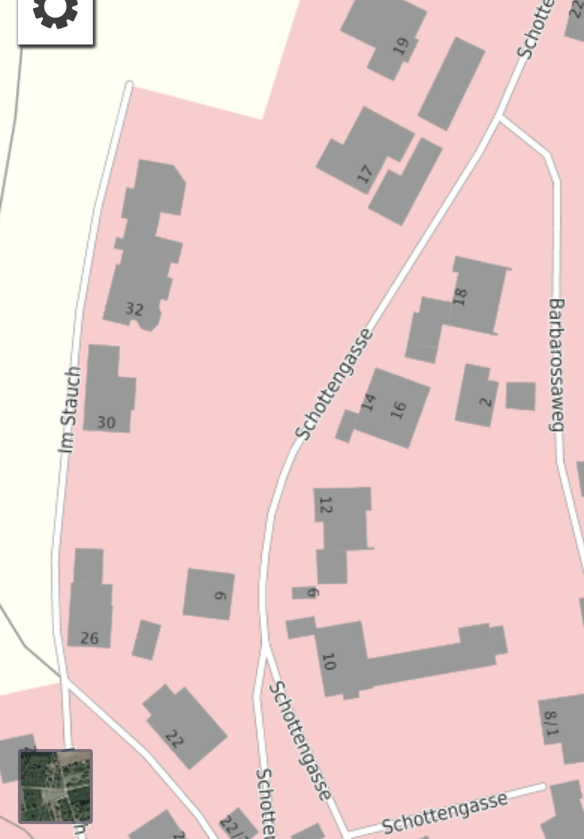 Site plan of a district with pink area, gray buildings, and Schottengasse/Barbarossweg.