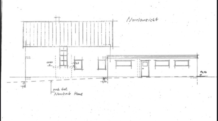 North view of a two-part house: left two storeys with gable roof, right flat roof extension.