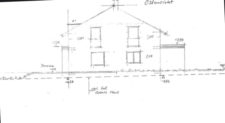 East view of a two-storey house with gable roof, windows and extension.