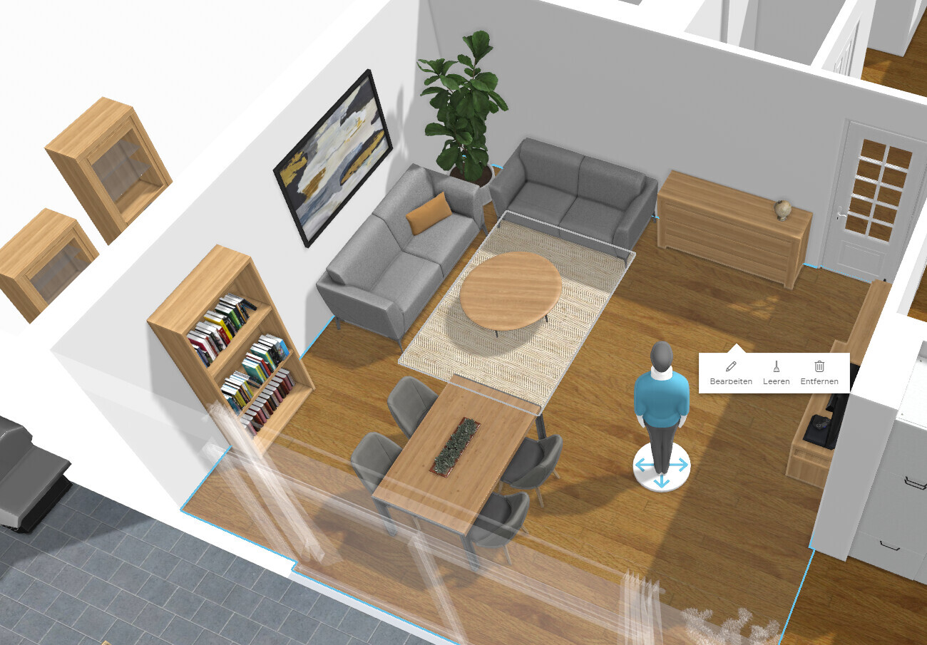 Living room with gray sofas, round wooden table, dining table with chairs, bookshelf, plant