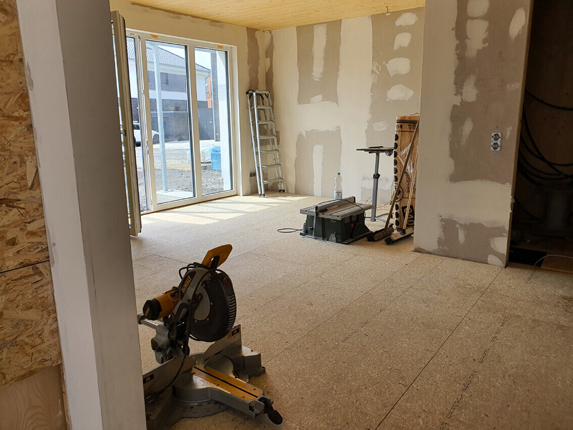 Renovation room with miter saw, ladder, tools, and sliding door
