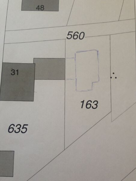 Site plan with parcel numbers and blue outline of a building